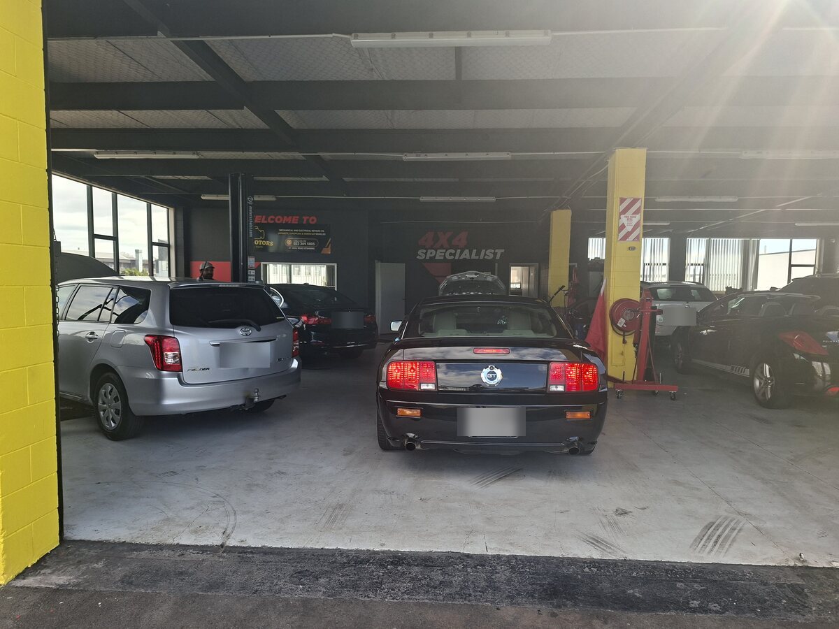 Customer vehicles in for service on the THI Motors workshop floor