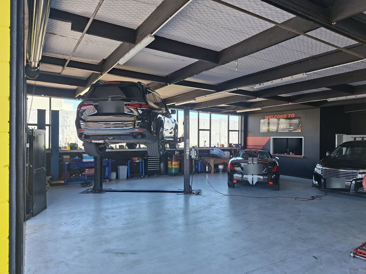 Mercedes-Benz SUV raised on a two-post hoist inside the Otahuhu workshop